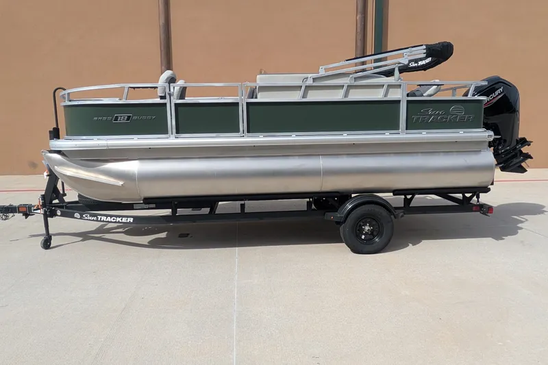 The Image of 2027 Sun Tracker Bass Buggy 18 DLX pontoon boat on trailer, side view. - 0