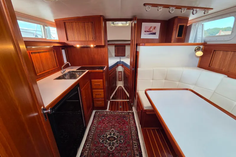 Slide: The Image of Luxurious interior of 1999 Fortier Express 33 yacht with wood finishes and cozy seating area. - 19