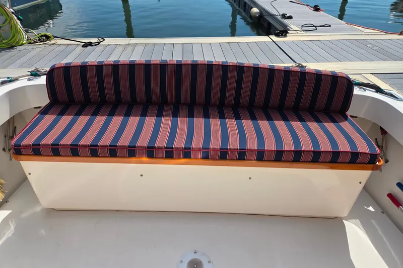 Slide: The Image of Striped bench seat on a 1999 Fortier Express 33 boat at the dock. - 17