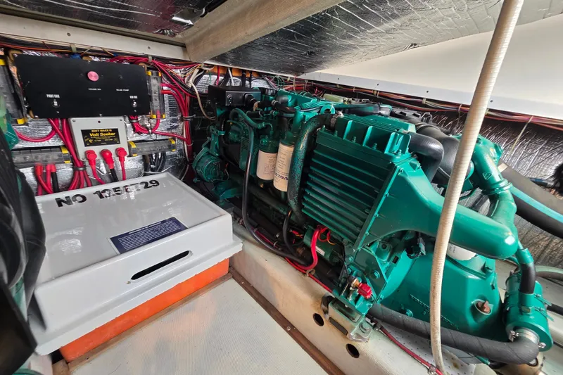 Slide: The Image of Engine room of a 1999 Fortier Express 33 boat, showcasing wiring and machinery. - 29