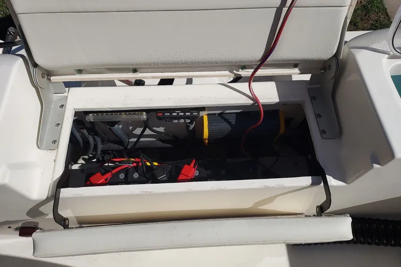 Slide: The Image of Open battery compartment of 2018 Cobia 220 Center Console boat, showing wiring and connections. - 12