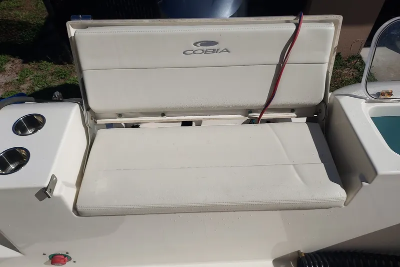 Slide: The Image of 2018 Cobia 220 Center Console boat seat with cup holders and storage compartment. - 6