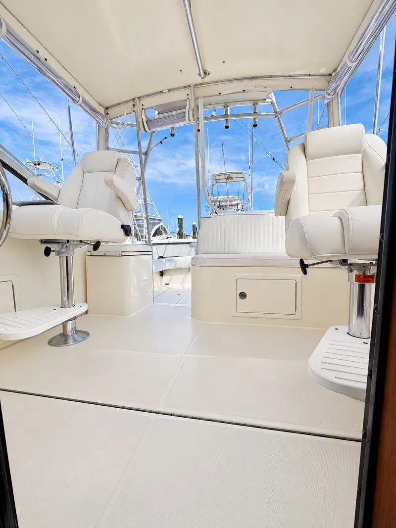 Slide: The Image of Interior of a 2005 Carolina Classic 28 Express with white seating and blue sky in the background. - 13