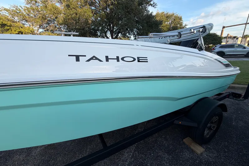 Slide: The Image of 2026 Tahoe T18 boat with white and turquoise hull on a trailer. - 2