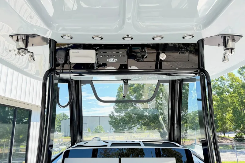 Slide: The Image of 2026 Sea Hunt Gamefish 30CB boat console with electronics and overhead storage. - 17