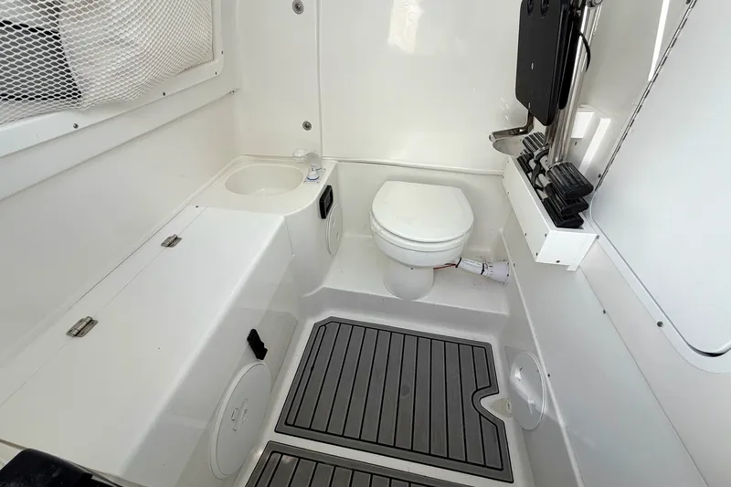 Slide: The Image of 2026 Sea Hunt Gamefish 30CB boat interior with toilet and sink. - 32