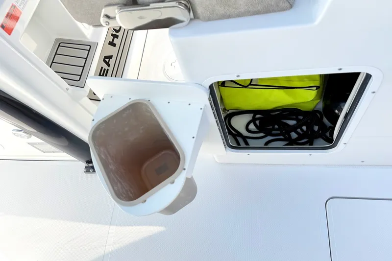 Slide: The Image of Storage compartment on 2026 Sea Hunt Gamefish 30CB boat with open hatch and visible gear. - 21