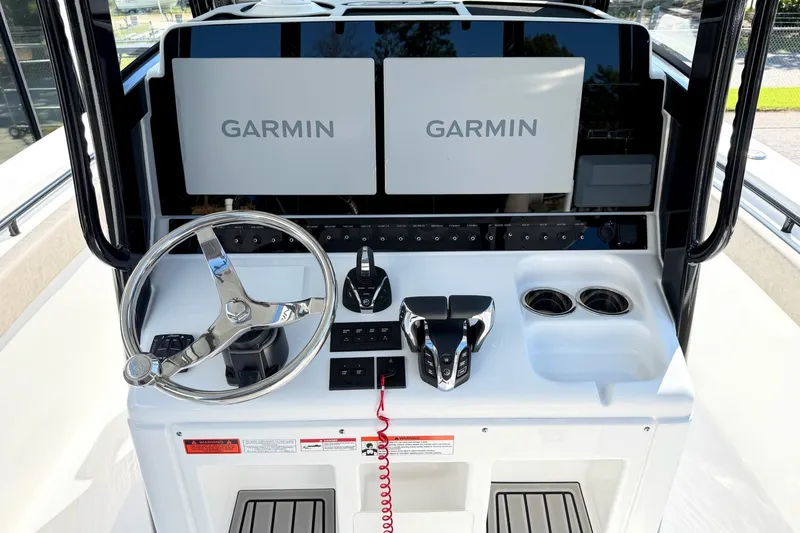 Slide: The Image of 2026 Sea Hunt Gamefish 30CB helm with dual Garmin displays and modern controls. - 16