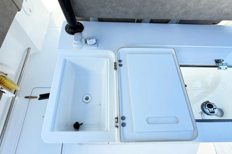 Slide: The Image of 2026 Sea Hunt Gamefish 30CB boat sink and storage area with white finish. - 14