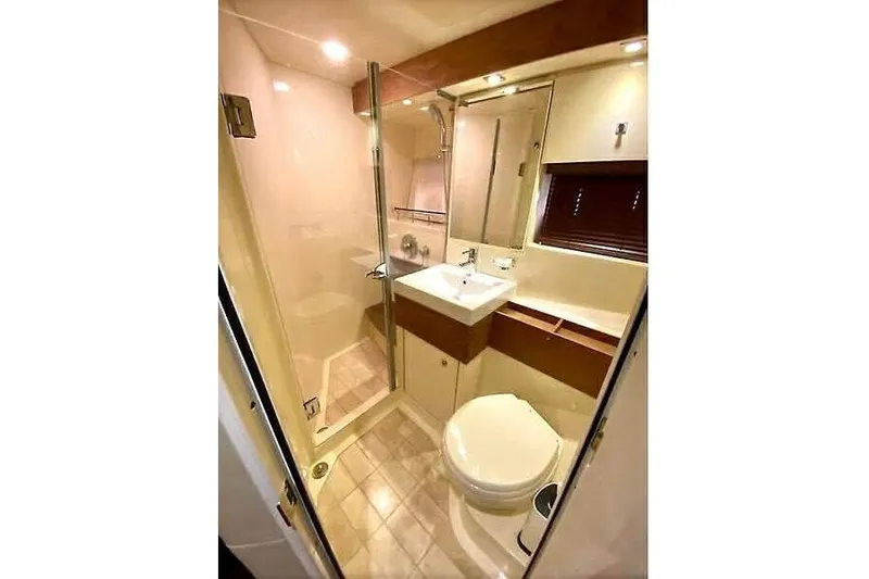 Slide: The Image of Luxurious bathroom in 2014 Sea Ray 410 Sundancer yacht, featuring modern fixtures and elegant design. - 31