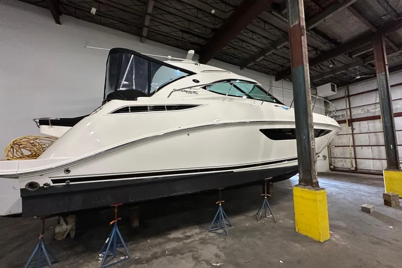 Slide: The Image of 2014 Sea Ray 410 Sundancer yacht in a warehouse, elevated on stands. - 42