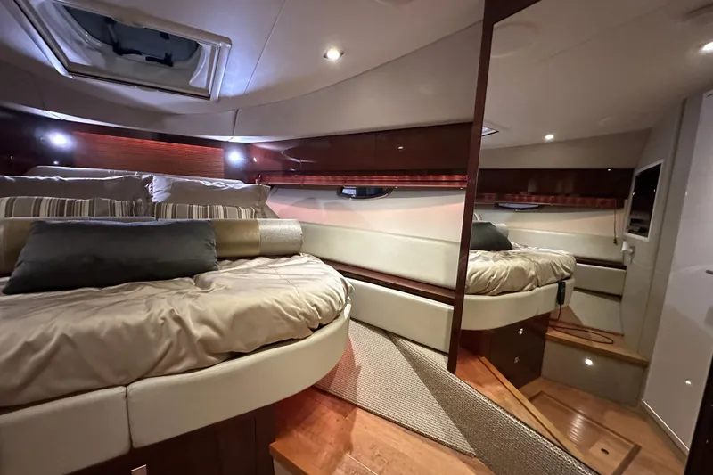 Slide: The Image of Luxurious interior of 2014 Sea Ray 410 Sundancer yacht with cozy bedding and elegant wood finishes. - 29