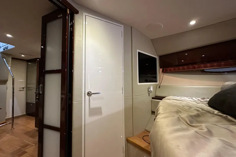 Slide: The Image of Interior of 2014 Sea Ray 410 Sundancer yacht, featuring a cozy bedroom and modern design. - 30