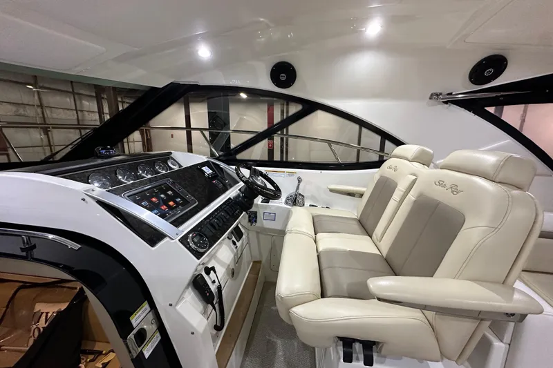 Slide: The Image of Interior cockpit of 2014 Sea Ray 410 Sundancer with modern controls and plush seating. - 14