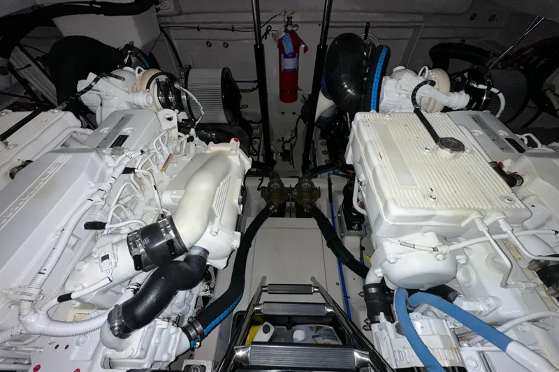 Slide: The Image of Engine room of a 2014 Sea Ray 410 Sundancer with dual engines and fire extinguisher. - 39