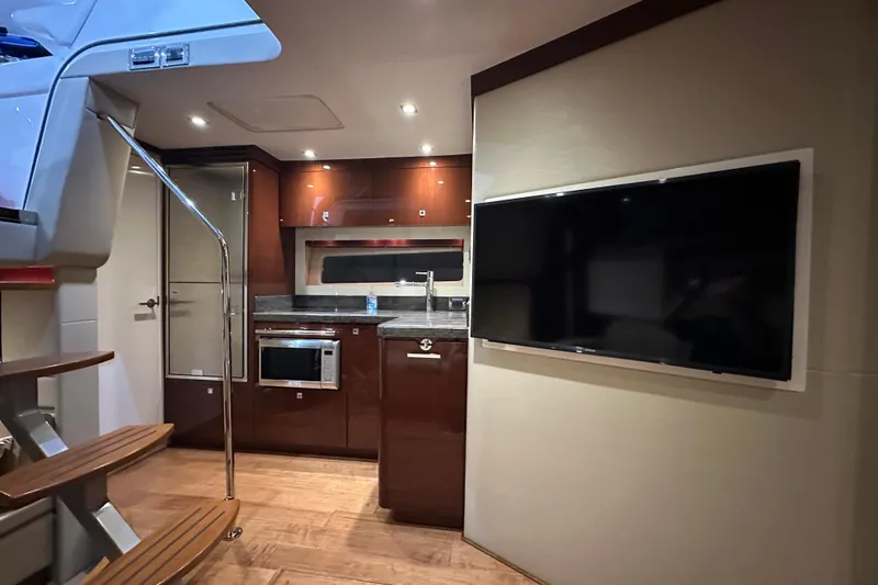 Slide: The Image of Luxurious interior of 2014 Sea Ray 410 Sundancer yacht with modern kitchen and TV. - 22