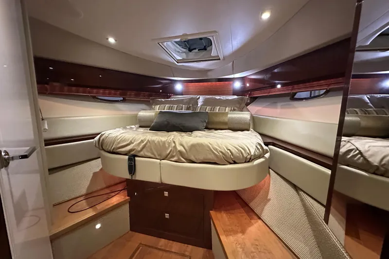Slide: The Image of Luxurious cabin interior of 2014 Sea Ray 410 Sundancer yacht with cozy bed and ambient lighting. - 28