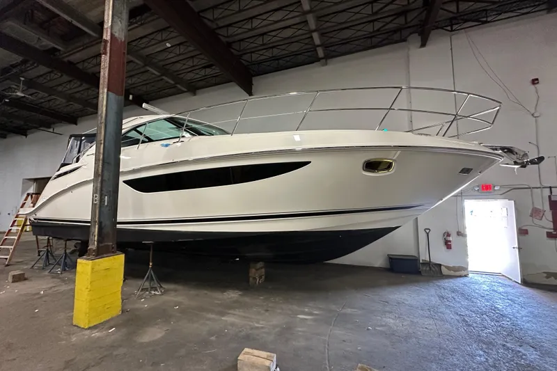 Slide: The Image of 2014 Sea Ray 410 Sundancer yacht in a warehouse, elevated on supports. - 41