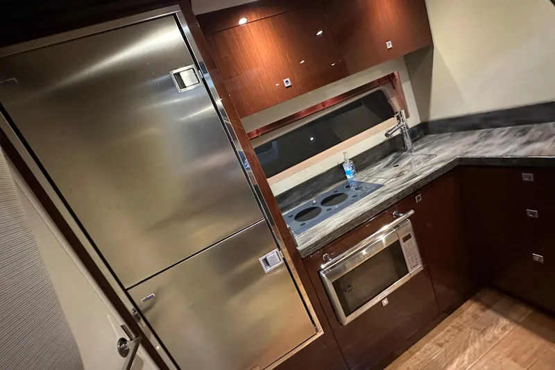 Slide: The Image of Luxurious 2014 Sea Ray 410 Sundancer yacht kitchen with modern appliances and sleek design. - 23