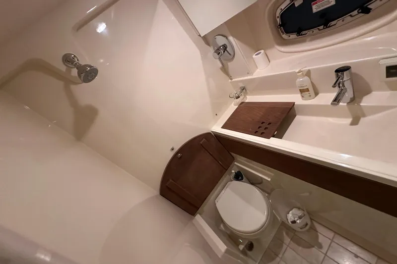Slide: The Image of Bathroom interior of 2014 Sea Ray 410 Sundancer yacht, featuring shower and sink. - 35