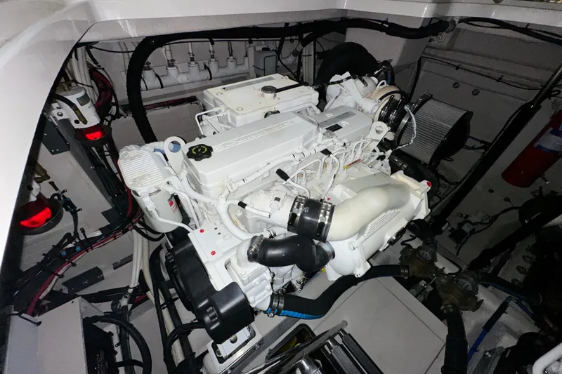 Slide: The Image of Engine room of a 2014 Sea Ray 410 Sundancer, showcasing a clean, well-maintained engine. - 38