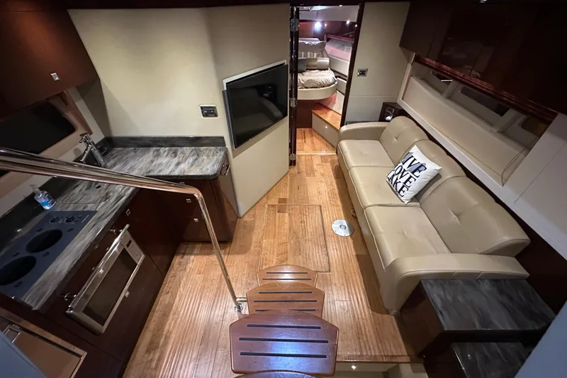 Slide: The Image of Luxurious interior of 2014 Sea Ray 410 Sundancer yacht with modern kitchen and cozy seating. - 20