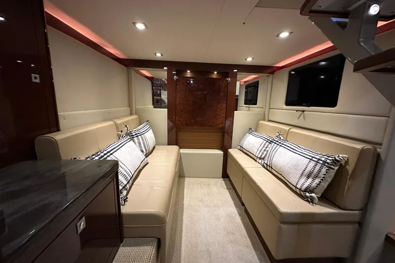 Slide: The Image of Luxurious interior of 2014 Sea Ray 410 Sundancer yacht with beige seating and modern lighting. - 25