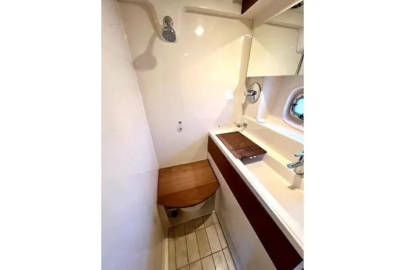 Slide: The Image of Bathroom interior of 2014 Sea Ray 410 Sundancer yacht, featuring shower and sink. - 36