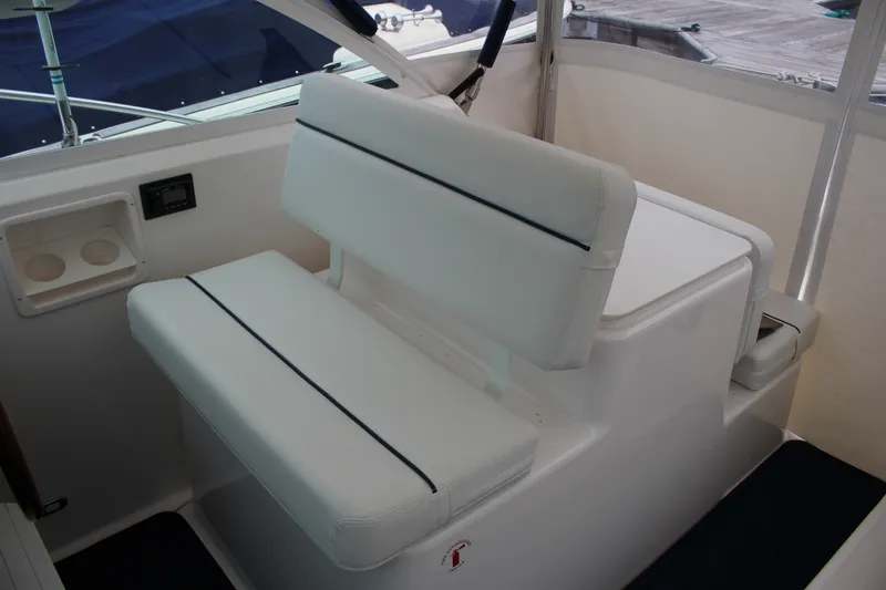 Slide: The Image of 2001 Tiara Yachts 2900 Coronet interior seating with cup holders and white upholstery. - 16