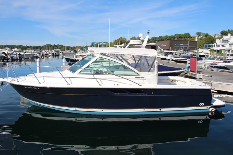 The Image of 2001 Tiara Yachts 2900 Coronet docked at a marina under clear blue skies. - 0