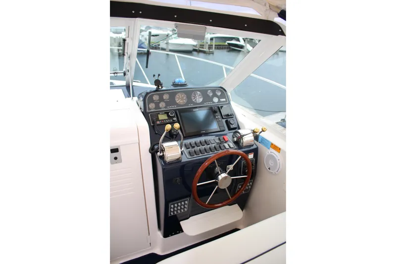 Slide: The Image of Helm of 2001 Tiara Yachts 2900 Coronet with steering wheel and control panel. - 14