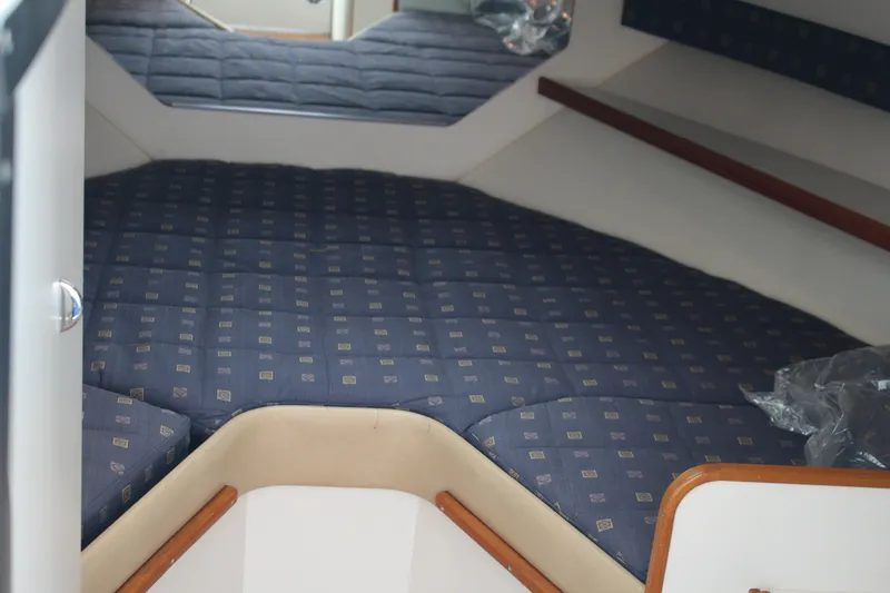 Slide: The Image of Interior cabin of 2001 Tiara Yachts 2900 Coronet with blue patterned bedding. - 22