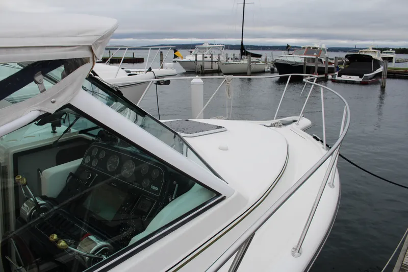 Slide: The Image of 2001 Tiara Yachts 2900 Coronet docked at marina, showcasing sleek design and control panel. - 35