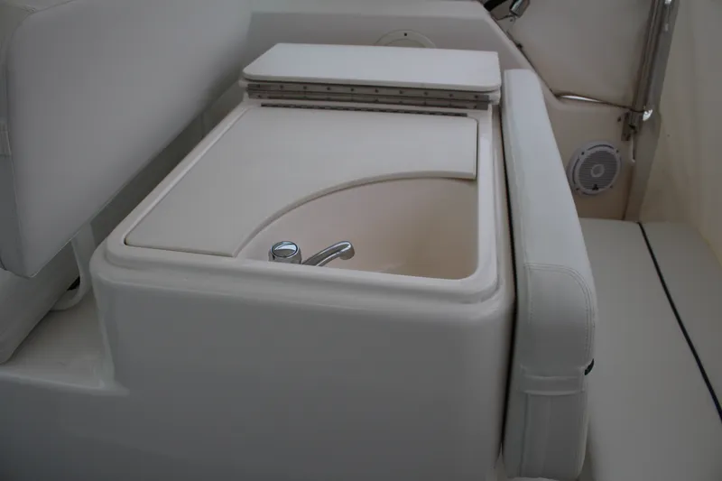 Slide: The Image of 2001 Tiara Yachts 2900 Coronet interior sink with white upholstery and faucet. - 29