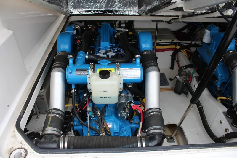 Slide: The Image of Engine compartment of a 2001 Tiara Yachts 2900 Coronet, showcasing blue marine engines. - 37