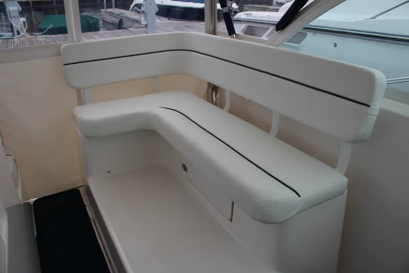 Slide: The Image of 2001 Tiara Yachts 2900 Coronet interior seating with white cushioned bench. - 17