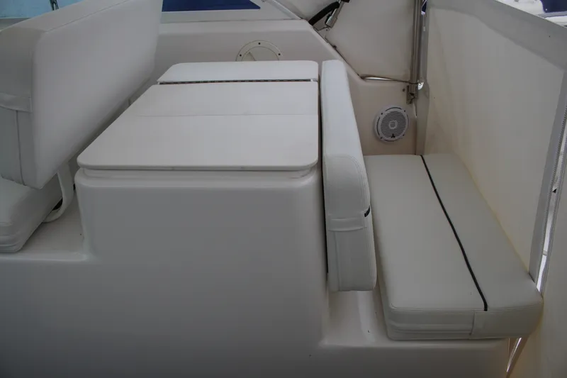 Slide: The Image of 2001 Tiara Yachts 2900 Coronet interior seating with white cushions and speaker. - 28