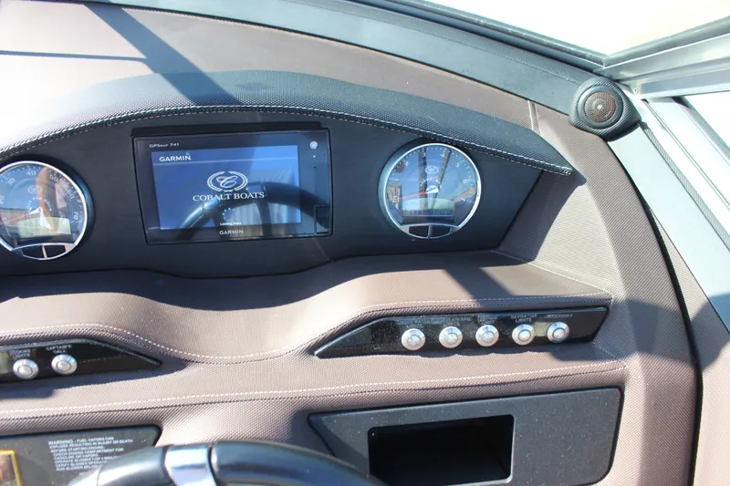 Slide: The Image of Dashboard of a 2016 Cobalt R5 WSS boat with Garmin display and controls. - 32