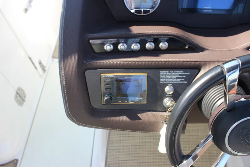 Slide: The Image of 2016 Cobalt R5 WSS boat dashboard with steering wheel and control panel. - 33