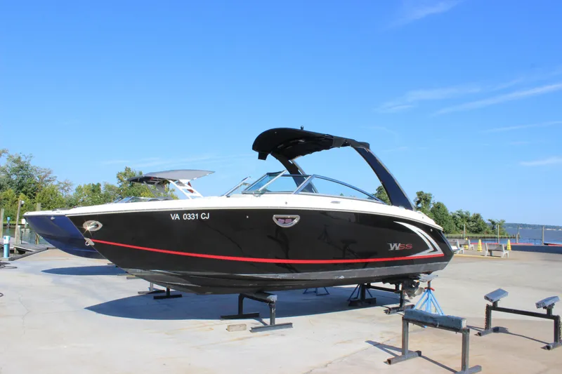 Slide: The Image of 2016 Cobalt R5 WSS boat on display, black with red accents, clear blue sky background. - 4