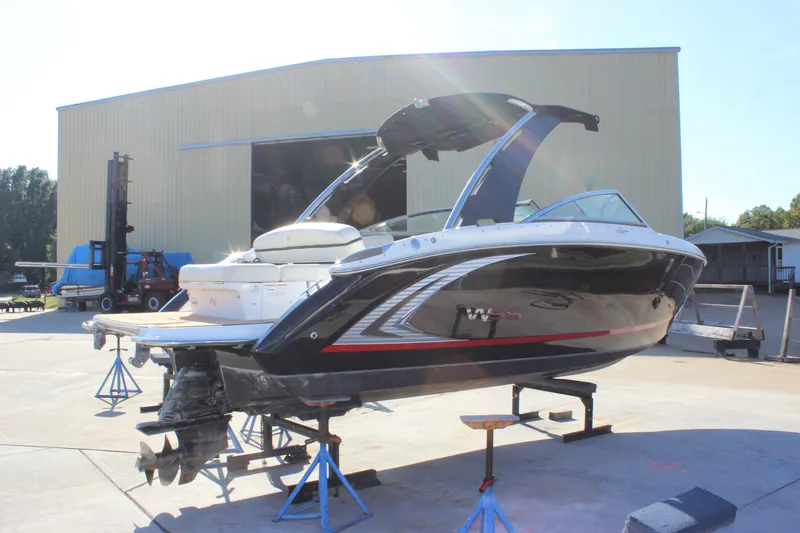 Slide: The Image of 2016 Cobalt R5 WSS boat on stands outside a large warehouse. - 8