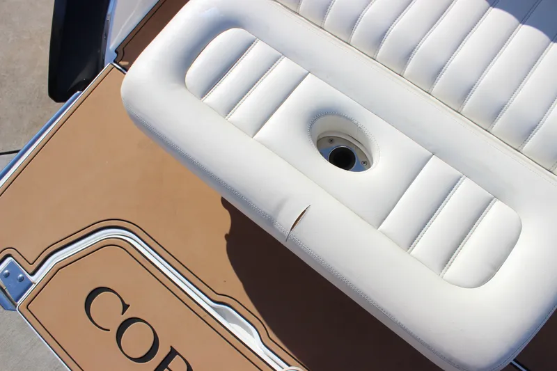 Slide: The Image of 2016 Cobalt R5 WSS boat interior with white cushioned seating and tan flooring. - 37