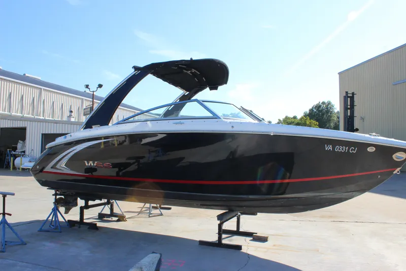 Slide: The Image of 2016 Cobalt R5 WSS boat on stands in a sunny marina setting. - 30
