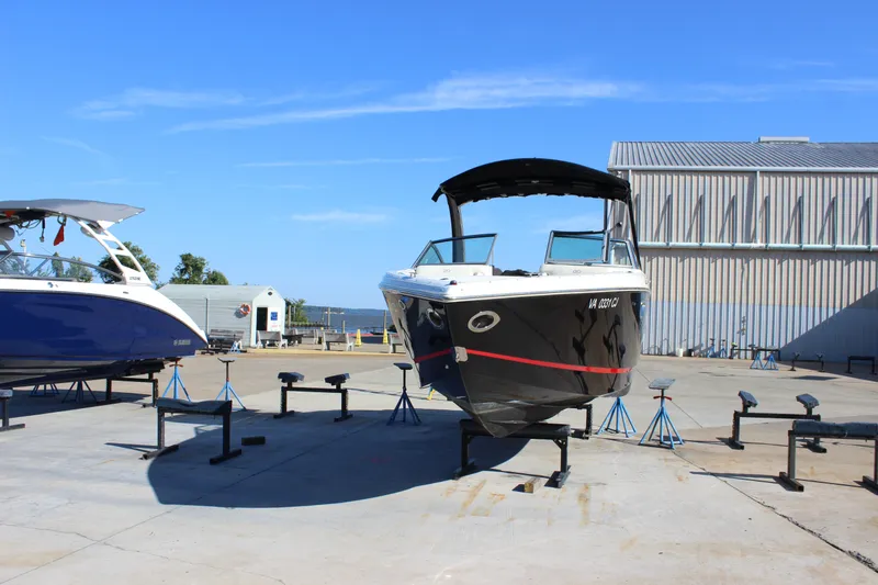 Slide: The Image of 2016 Cobalt R5 WSS boat on stands in a marina under clear blue sky. - 5