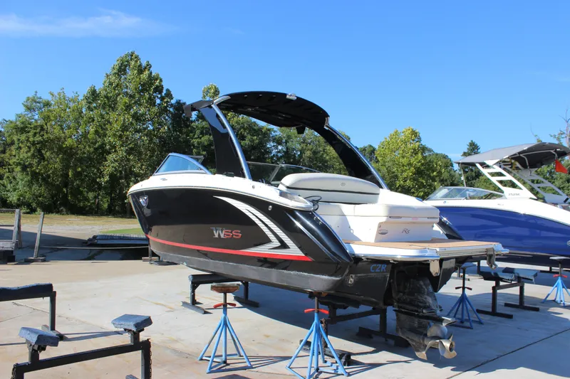 Slide: The Image of 2016 Cobalt R5 WSS boat on stands, outdoors, with trees in the background. - 21