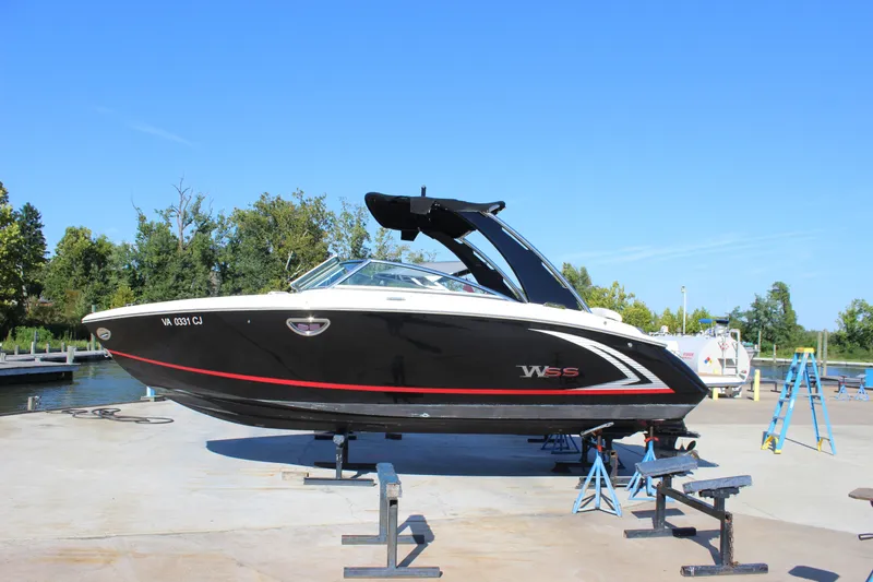 Slide: The Image of 2016 Cobalt R5 WSS boat on stands, black with red accents, dockside setting. - 3
