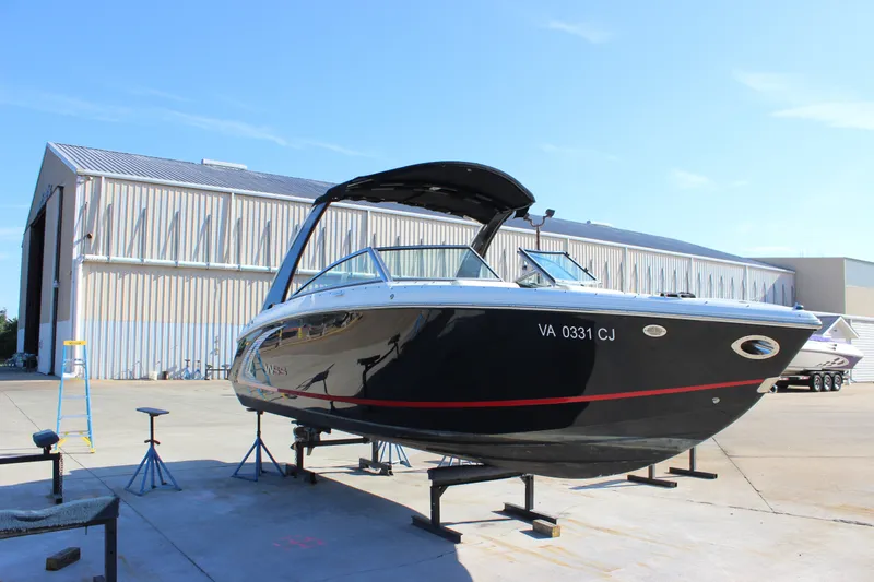 Slide: The Image of 2016 Cobalt R5 WSS boat on stands outside a large warehouse. - 29