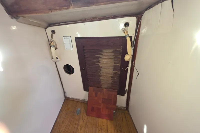 Slide: The Image of Interior of a 1970 Newport 41 boat with wooden flooring and paneling. - 8