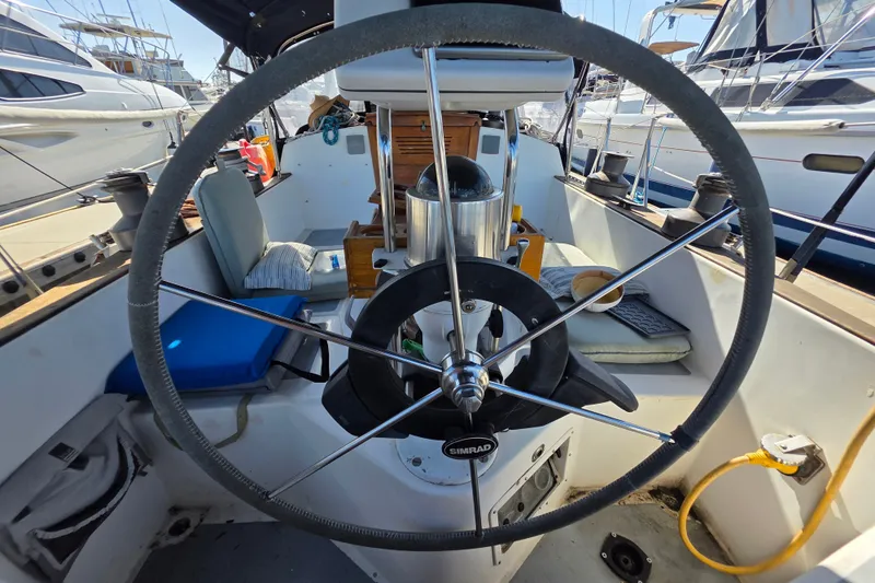 Slide: The Image of Cockpit of a 1970 Newport 41 sailboat with steering wheel and seating. - 23