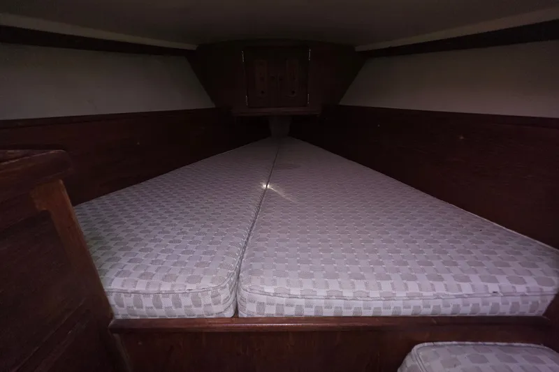 Slide: The Image of Interior cabin of a 1970 Newport 41 sailboat with cushioned sleeping area. - 9